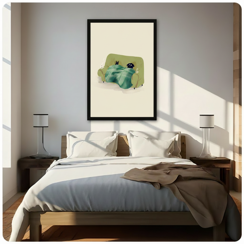 Black framed cozy black cat and dog cuddled under a blanket on a couch canvas art with an olive green sofa, teal throw, and two steaming coffee mugs on a cream background, hung above a wooden bed frame in a sun-drenched minimalist bedroom with crisp white linen bedding and matching cylindrical nightstand lamps