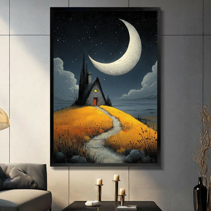 Dark illustration of a stone cottage with a glowing window on a golden hillside path under a giant crescent moon and starry night sky gothic landscape wall art framed print in living room with light gray panel wall and dark sofa