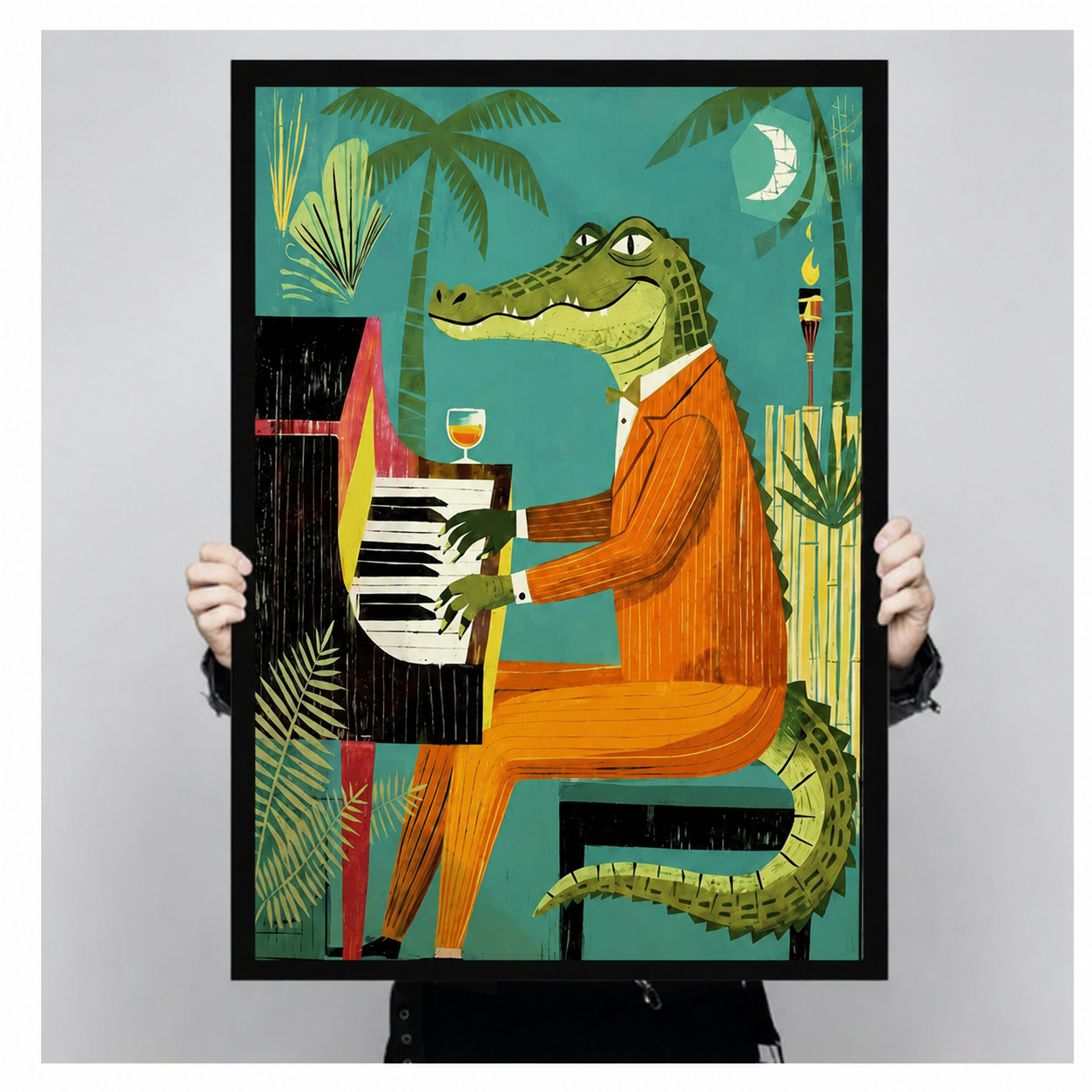 Person holding a large black framed jazz crocodile in orange suit playing piano with tiki torch and palm trees art print showing print size scale and bold teal illustration detail