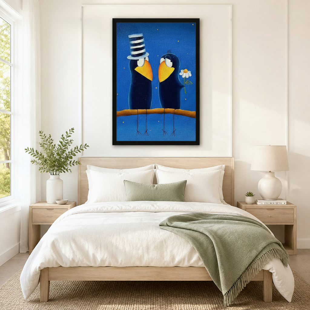 Black framed whimsical folk art romantic crow couple canvas art with two round dark navy blue cartoon crows perched together on a warm amber branch gazing at each other lovingly, the left crow wearing a tall black and white striped stovepipe hat and the right crow clutching a white daisy flower, both with broad golden yellow beaks and white eye rings on a rich deep blue starry night background scattered with tiny gold light dots, hung above a light wood bed frame in a serene Scandinavian bedroom with crisp 