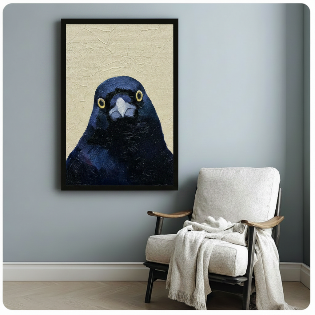 Moody dark blue crow portrait framed poster beside cozy armchair, expressive bird face with golden eyes on beige textured background, black frame wall art