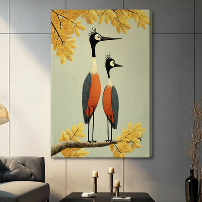 Whimsical folk art illustration of two crowned cranes standing together on a branch with orange-red plumage blue-gray wings large round eyes and long black beaks surrounded by golden autumn foliage bird couple wall art stretched canvas in living room with light gray panel wall and dark sofa
