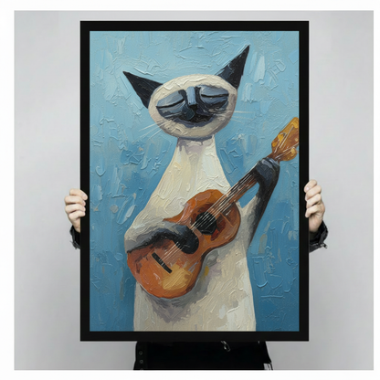 Person holding large framed cubist style oil painting Siamese cat standing upright playing acoustic guitar with eyes closed in musical bliss thick impasto brushstrokes on vibrant sky blue textured background canvas print with both hands against neutral grey background - close up size reference of expressive Siamese cat guitar player blue wall art with black frame finish