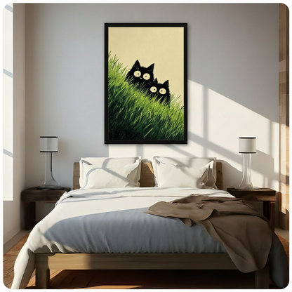 Two adorable black cats peeking through lush green grass with big eyes minimalist illustration framed wall art print hanging above a modern bedroom bed with white linen bedding, dark wood nightstands, and minimalist white table lamps