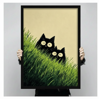 Funny black cat duo with big round eyes hiding in tall green grass cute minimalist illustration framed wall art print held up for size reference against a light gray neutral background