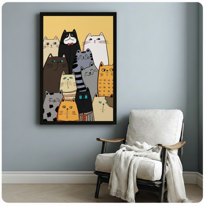 Black framed vertical poster of cute illustrated cats in warm amber tones, styled beside a linen armchair on blue-grey wall