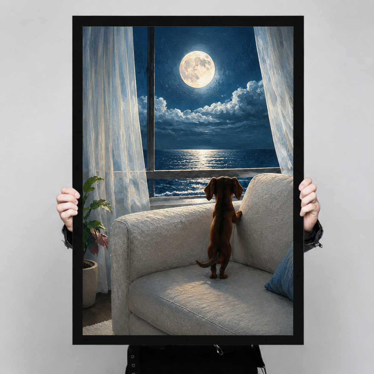 Close-up of a canvas art print showing a dachshund on a white sofa watching moonlight reflect on the ocean through an open window