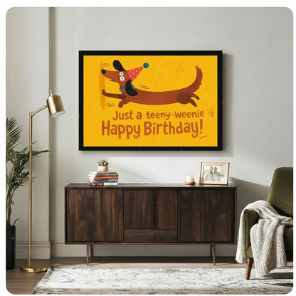Whimsical dachshund in party hat birthday wall art canvas in black frame above wooden sideboard in warm-toned living room