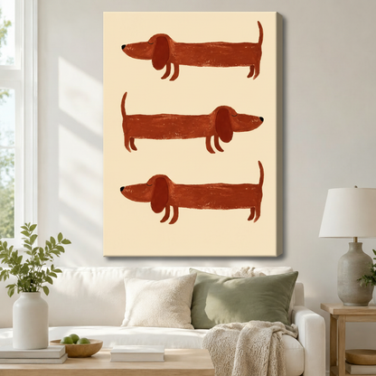 Gallery wrap canvas of three whimsical dachshund illustrations in terracotta tones hung above a white linen sofa, adding playful boho charm to a neutral living room