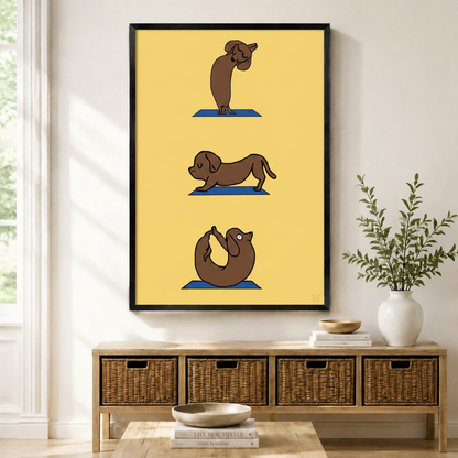 Framed canvas print of a cartoon dachshund dog performing three yoga poses on blue mats against a bright yellow background, displayed above a wicker basket sideboard in a modern entryway