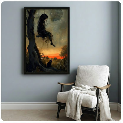 Black framed dark fantasy girl on tree swing with black cat and crimson sunset art print on a light blue-grey wall beside a white linen armchair with draped throw blanket
