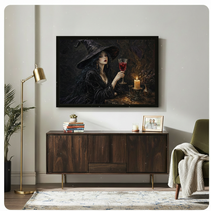 Dark atmospheric oil-style framed wall art of an elegant witch in black raising a crimson wine goblet by candlelight, displayed above a walnut sideboard in a warm eclectic living room