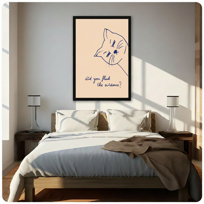 Humorous cat poster in black frame above bed in minimalist bedroom with warm morning sunlight, funny wall art
