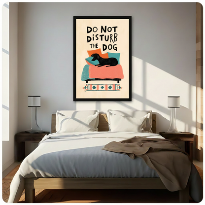 Do Not Disturb The Dog black framed print hanging above a bed in a bright Scandinavian-style bedroom with wooden nightstands