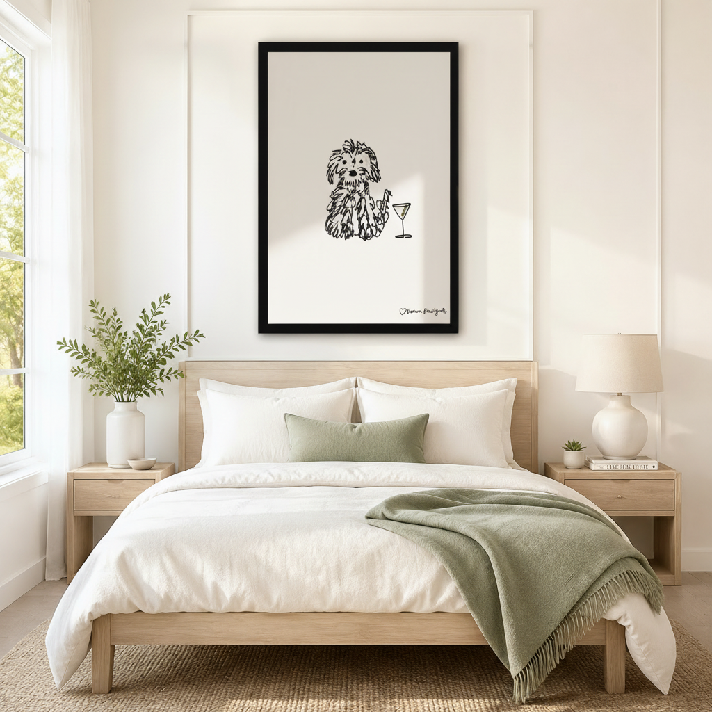 Framed minimalist dog with martini glass ink drawing centered above bed as statement wall art in Scandinavian bedroom