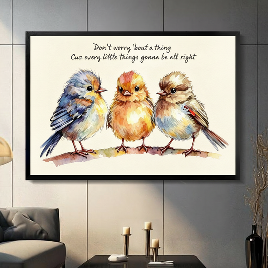 Whimsical watercolor illustration of three plump birds perched in a row with fluffy feathers in blue-gray orange-yellow and brown tones and a handwritten motivational quote above on a warm cream background positive bird quote wall art framed print in a living room with dark gray panel wall dark sofa and black vase