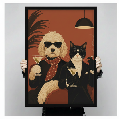 Bold retro poster illustration of a Goldendoodle wearing black sunglasses a black coat and a red polka dot scarf holding up a martini glass with olives alongside a black-and-white tuxedo cat in dark shades a black suit and white pocket square holding a cocktail and a cigarette against a deep terracotta red background with dark palm frond and hanging lamp funny pet cocktail party wall art framed wall art print held up for size reference against a light gray neutral background