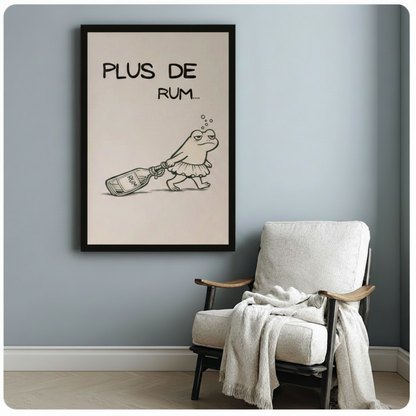 Black framed minimalist black and white line art drunk frog in tutu skirt dragging rum bottle with Plus De Rum text canvas print beside white linen armchair on blue-grey wall - funny tipsy frog rum quote wall art on soft cream background for reading nook or bedroom decor