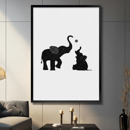 Black framed canvas wall art featuring minimalist black and white elephant mother and baby playing with a ball, displayed in a modern living room above a dark coffee table