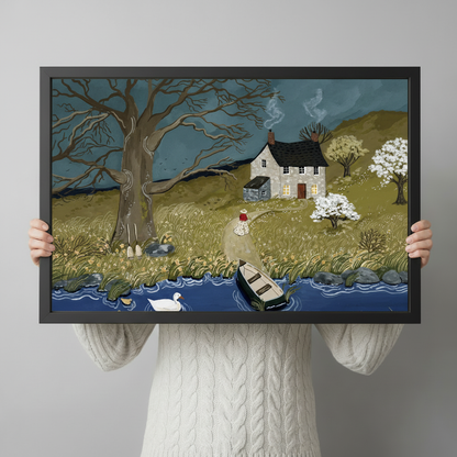 Person holding framed English countryside folk art print showing cottage river and swan, size reference for wall art
