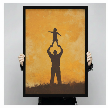 Hand-held display of framed father and child silhouette wall art print with warm amber background, showing print size and frame detail