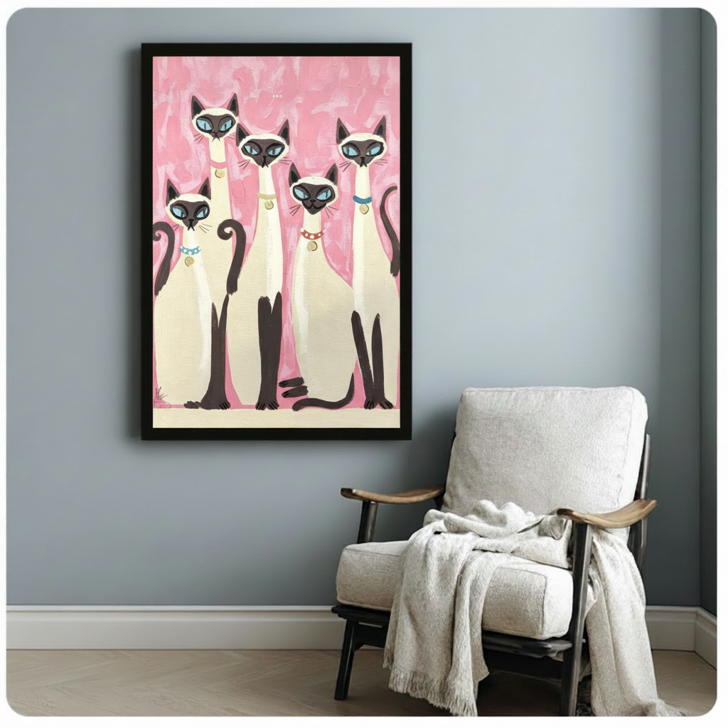 Retro folk art painting of five Siamese cats with blue eyes and colorful collars grouped together on a pink brushstroke background cat wall art framed print beside white armchair on blue-gray wall