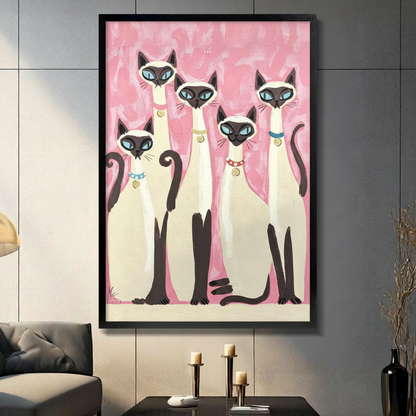 Retro folk art painting of five Siamese cats with blue eyes and colorful collars grouped together on a pink brushstroke background cat wall art framed print in living room with dark gray panel wall and dark sofa