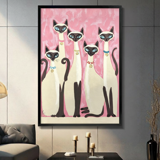 Retro folk art painting of five Siamese cats with blue eyes and colorful collars grouped together on a pink brushstroke background cat wall art framed print in living room with dark gray panel wall and dark sofa