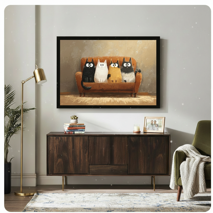 Black-framed cartoon cat art print hung above a mid-century walnut sideboard in a light-filled living room, featuring four quirky cats on an orange velvet sofa