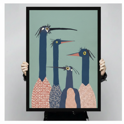 Person holding large four quirky long-neck birds framed wall art print showing actual size with teal background
