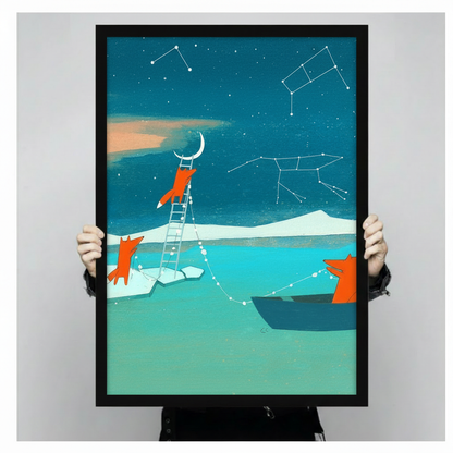 Close-up size reference of a black-framed whimsical fox art print featuring three orange foxes, a ladder reaching the crescent moon, and star constellation lines on a teal night sky, held by two hands