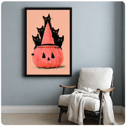 Framed Halloween cat and pumpkin wall art beside a white armchair against a blue-gray wall.