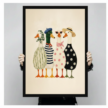 Four anthropomorphic ducks in matching French fashion ensembles with blue beret, straw boater hat, red sunglasses, pink scarf, and patterned dresses in stripes, polka dots, and daisies colorful illustration framed wall art print held up for size reference against a light gray neutral background