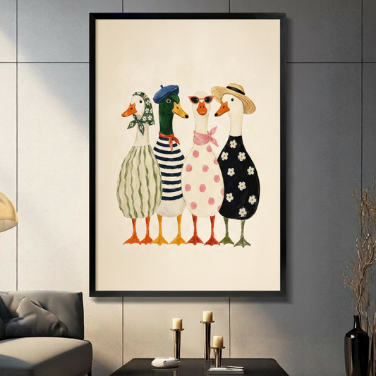 Four fashionable anthropomorphic ducks in French style outfits including striped dress, navy sailor top, pink polka dot dress, and black daisy dress with beret, straw hat, floral headscarf, and red sunglasses cute illustration framed wall art print displayed in a living room with dark gray sofa, pillar candle holders, and black decorative vase