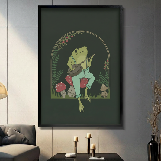 Framed whimsical wall art of a green frog in overalls playing a banjo surrounded by red mushrooms and ferns in a dark forest arch, displayed in a modern dark grey living room