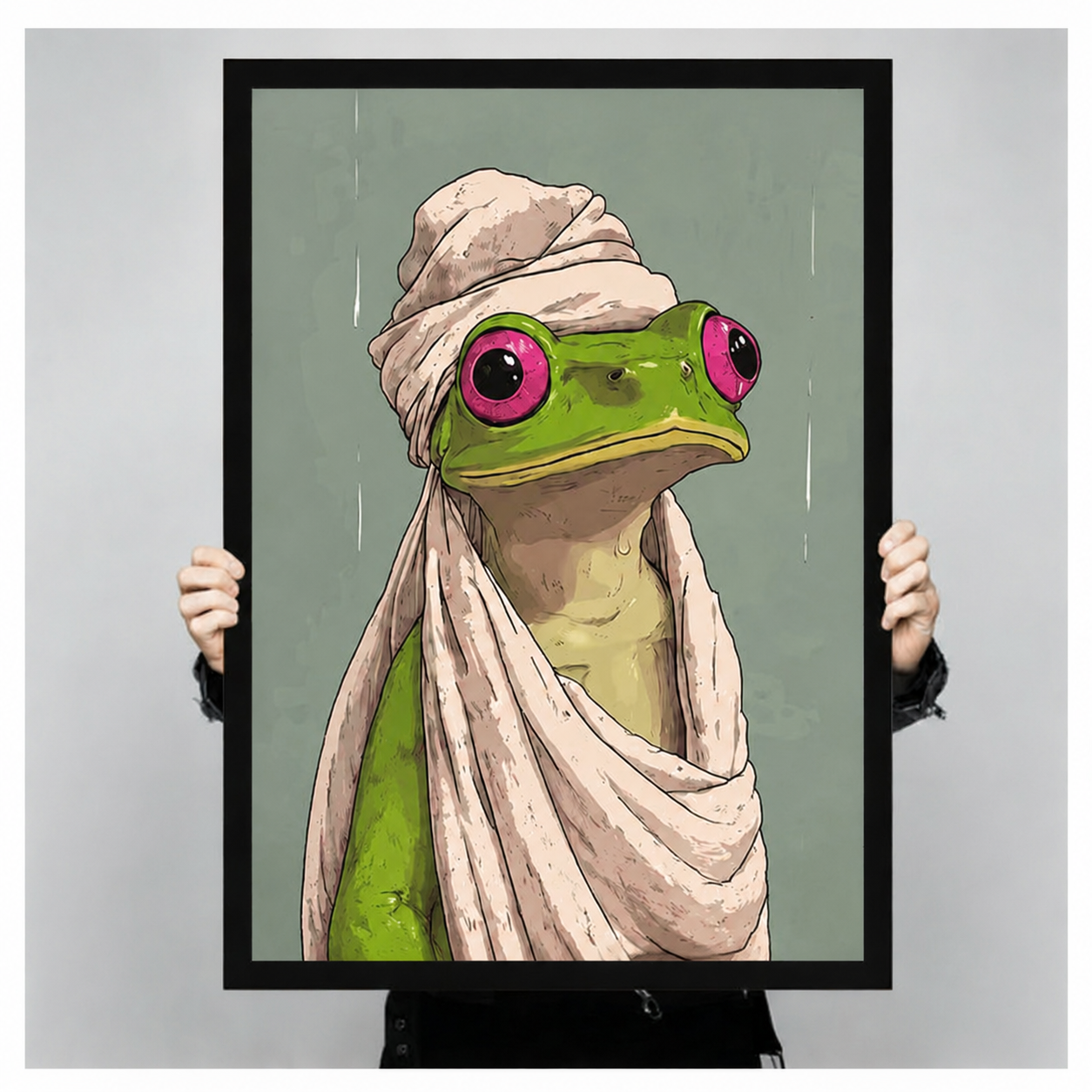Person holding large black framed frog in towel wall art print, funny bathroom decor poster size reference