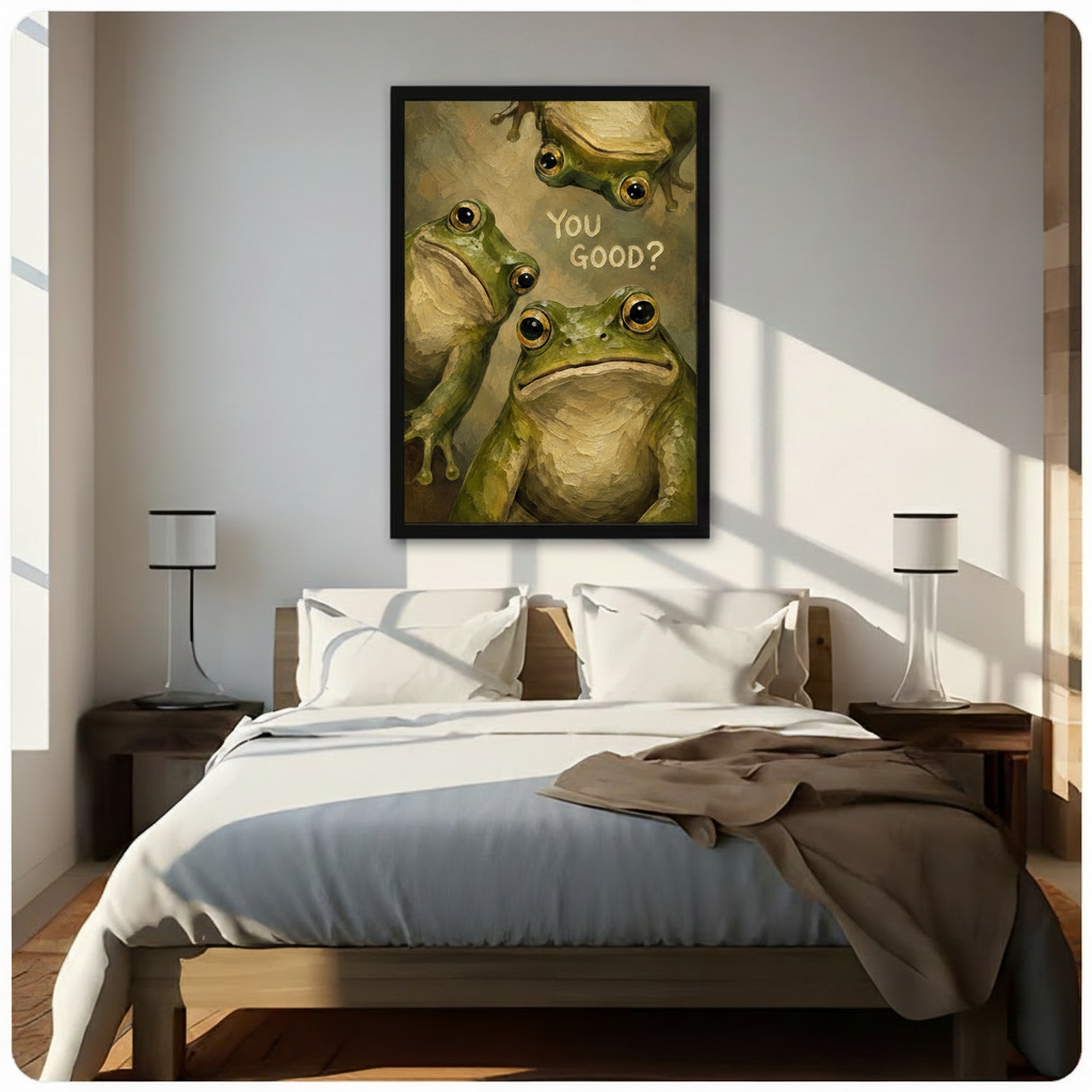 Black framed charming humor oil painting of three green bullfrogs with expressive golden eyes crowding the canvas including a top-hanging frog and a large front-facing frog with You Good hand-lettered text whimsical frog canvas wall art on olive gold impasto background hung above a dark wood bed with white linen bedding