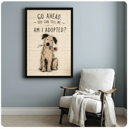 Black framed whimsical hand-drawn shaggy dog with daisy canvas art featuring an innocent wide-eyed scruffy dog holding a flower and the am I adopted quote in playful lettering on a vintage linen-textured background, displayed on a soft blue-gray wall beside a white wooden folding armchair draped with a cream linen throw blanket