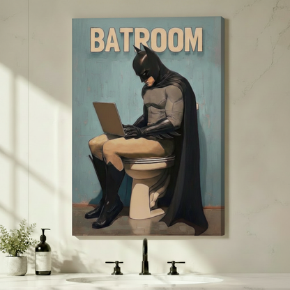 Humorous Batman on toilet using laptop Batroom canvas wrap wall art hung on a light gray bathroom wall above a black faucet sink with soap dispenser and green plant