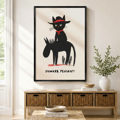 Black framed funny cowboy black cat on donkey illustration with bold red accents and "Onward Peasant" text mounted above a wicker basket storage console with white ceramic vases, stacked books, and a wooden bowl in a warm minimal entryway