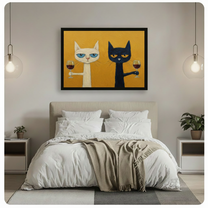 Black framed funny cats drinking wine canvas art with a deadpan white cat and a grumpy dark navy cat each holding a glass of red wine on a mustard yellow textured background, hung above a bed with white linen bedding and glass pendant lights in a modern bedroom