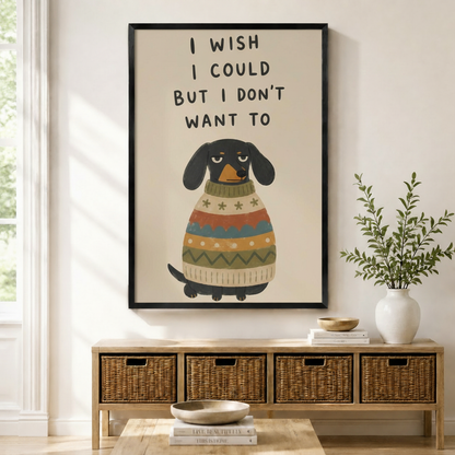 Black framed funny dachshund I Wish I Could But I Don't Want To quote canvas art with a grumpy black dachshund in a colorful striped sweater, displayed above a rattan storage console in a bright entryway
