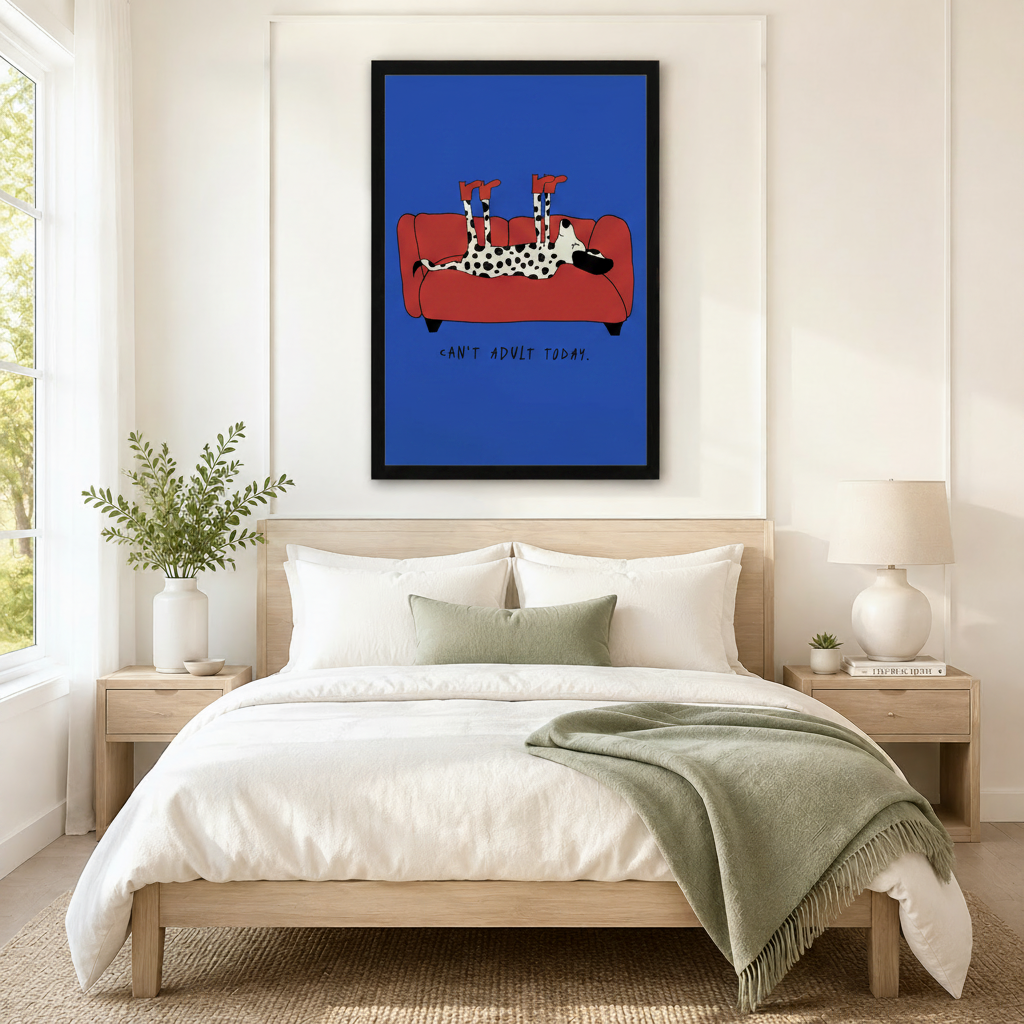 Black framed Dalmatian "Can't Adult Today" canvas art in cobalt blue above a bed with white linen bedding, a sage throw blanket, and wooden nightstands in a modern bedroom