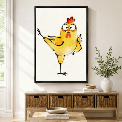 Black framed whimsical watercolor funny dancing chick canvas art with a round golden yellow cartoon chicken balancing on one leg with both wings spread wide in a joyful dance pose, a red comb on top, large round eyes, an orange beak, and a red wattle on its chest, rendered in loose watercolor washes with expressive black ink sketch outlines on a clean off-white background, displayed above a wooden rattan storage bench with a white ceramic bowl, stacked books, and a white vase of greenery