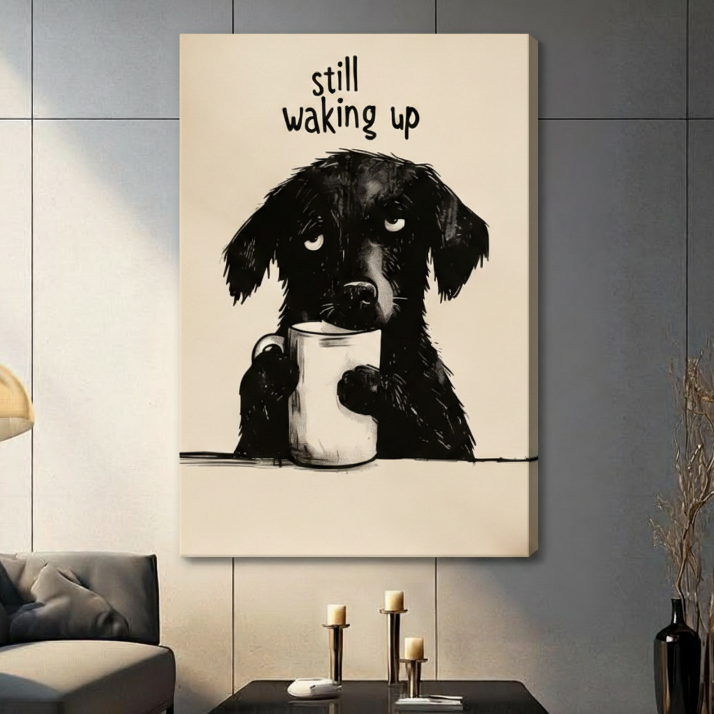 Humorous pencil illustration fluffy black dog clutching white coffee cup with tired eyes "Still Waking Up" gallery wrap canvas art on warm beige background on a dark gray paneled wall above a charcoal sofa with candle holders and a black vase