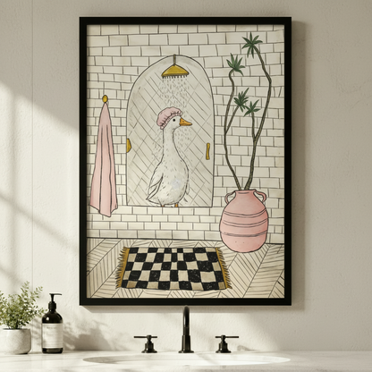 Funny white goose in pink shower cap bathroom illustration in black frame above a white bathroom sink with black faucet, soap dispenser, and small potted plant on a white marble countertop