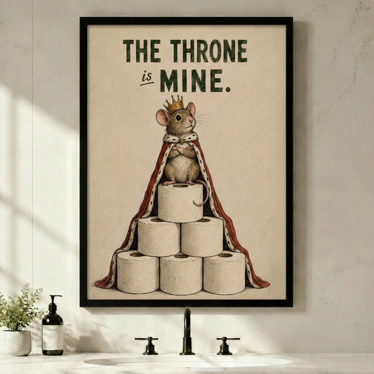 Framed vintage humorous illustration crowned mouse wearing royal red ermine cape sitting atop pyramid of toilet paper rolls with bold text The Throne Is Mine on aged cream background canvas print on white wall above black bathroom faucet sink with soap dispenser and small green plant - funny bathroom king mouse toilet paper wall art for contemporary powder room decor