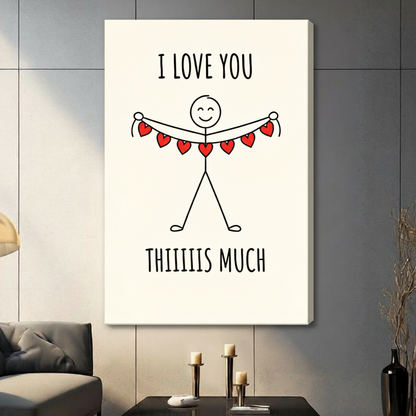 Cute stick figure holding red heart bunting canvas print with I Love You Thiiiis Much quote hung on a dark gray wall in a modern living room with neutral sofa