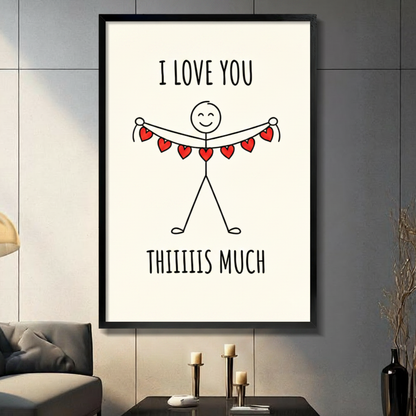 Funny I Love You Thiiiis Much stick figure wall art in black frame displayed on a dark gray living room wall above a gray sofa with candle holders on a side table