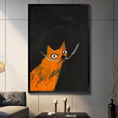Funny orange cat with wide eyes and long whiskers — black framed canvas art displayed in a moody dark living room with candlesticks
